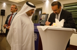 Mehran Kamrava signs a copy of his new book, "Qatar: Small State, Big Politics."